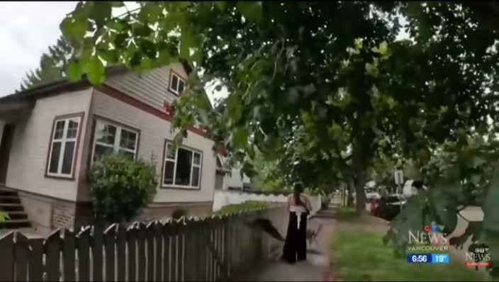 Leah walks along a leafy neighbourhood street.